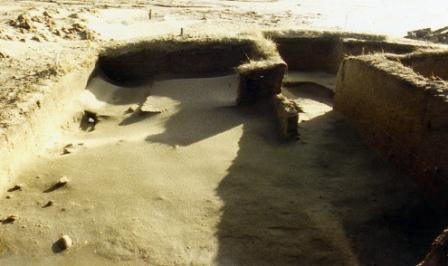 Wind blown sand covers the excavation