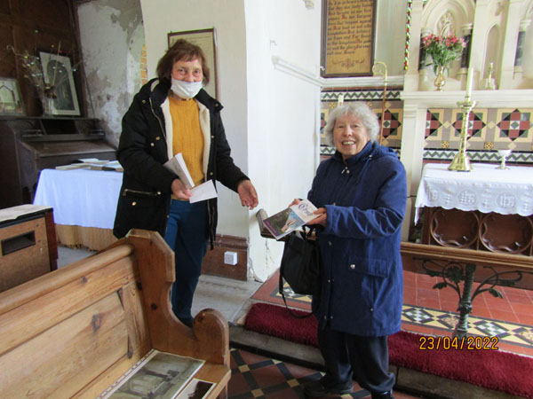 Dorothy Smith presents church warden, Pat Leckonby with the Easington church book